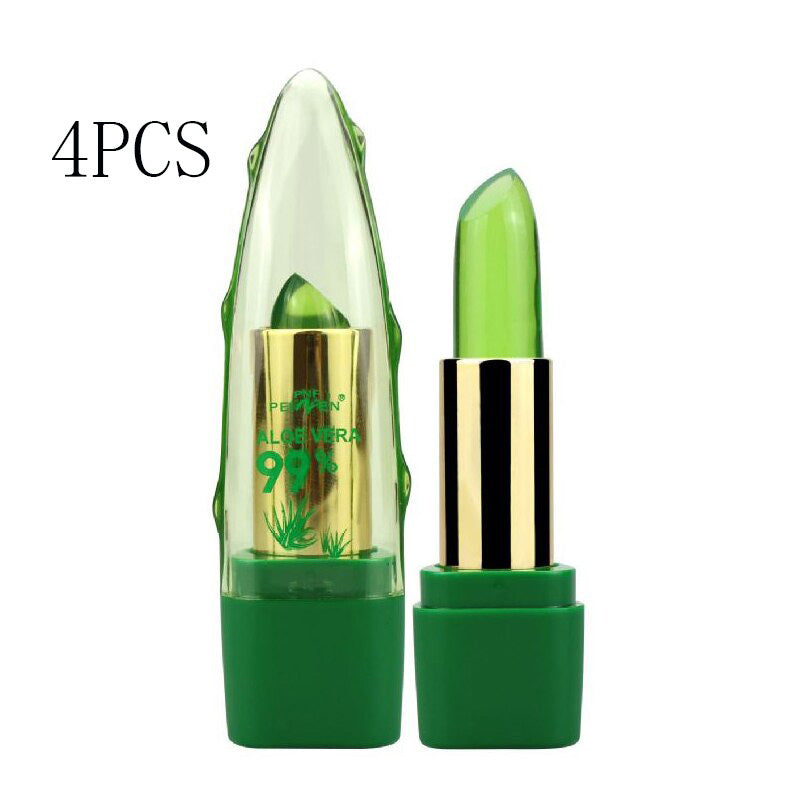 Image of four pieces of Sweet Deals Aloe Vera Gel Color Changing Lipstick Gloss Moisturizer Anti-drying Desalination Fine-grain Lip Balm Care labels, displayed in a transparent, crystal-shaped casing alongside one uncapped green lipstick.