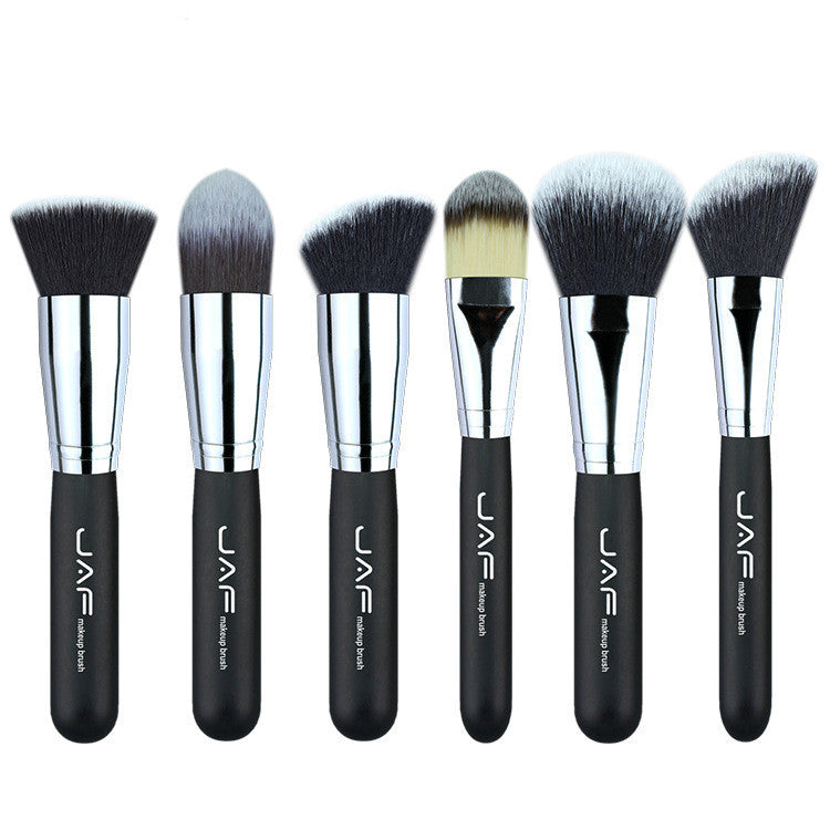 A collection of 24 Sweet Deals professional makeup brushes with black handles and silver ferrules, displayed side by side in a good makeup brush bag with varying brush head shapes and sizes for different makeup applications.