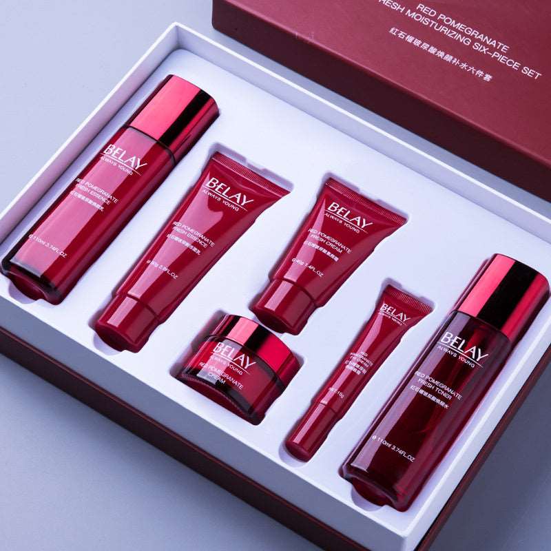 A skin care gift set with six red and silver containers of varying sizes displayed in an elegant grey box. The set includes moisturizing creams and serums, labeled &quot;Sweet Deals Beauty Salon Facial Care Cosmetics&quot;.