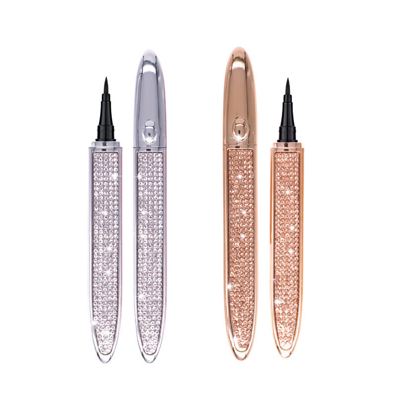 Two elegant Magic Lashes Self-adhesive Liquid Eyeliner Pens, one silver and one rose gold, each adorned with sparkling crystals, isolated on a white background.
