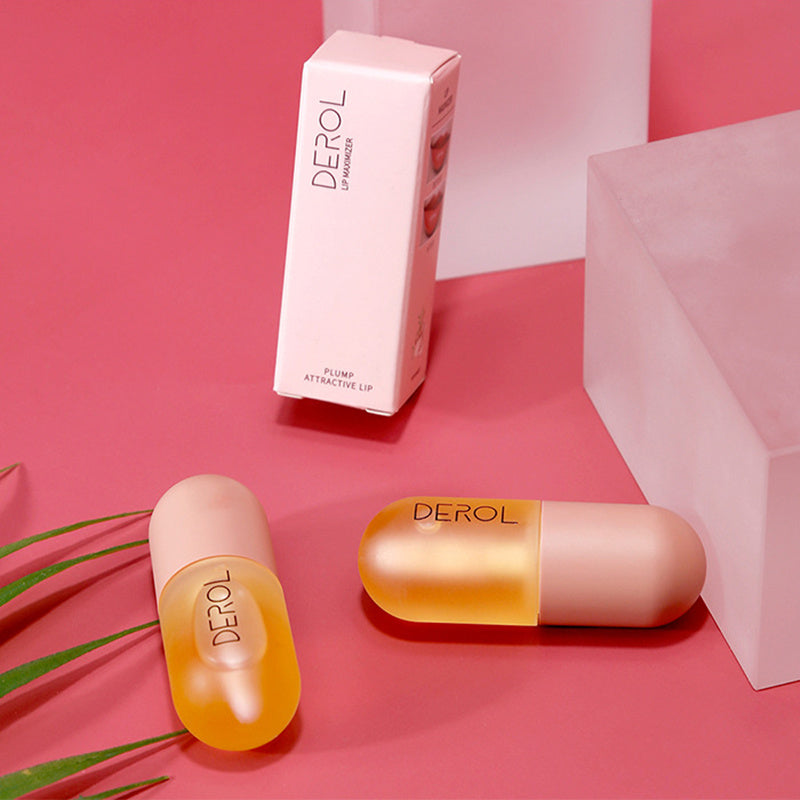 Two Day Night Instant Volume Lip Plumper Oils by Sweet Deals on a pink background, with one standing upright and the other lying down next to a white box and a green plant.